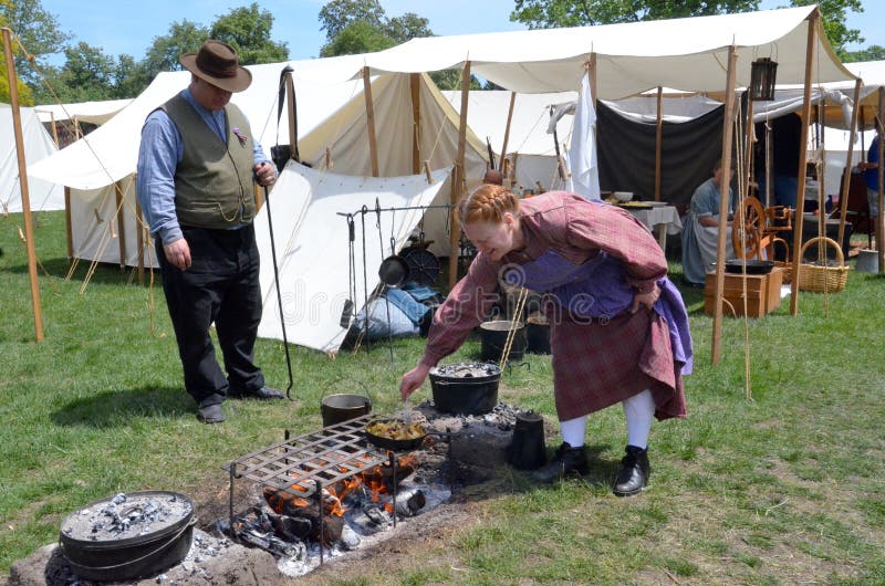 DEARBORN, MI - MAY 26: Civil-war era re-enactor cooking during the Civil War remembrance at Greenfield Village May 26, 2013. DEARBORN, MI - MAY 26: Civil-war era re-enactor cooking during the Civil War remembrance at Greenfield Village May 26, 2013.