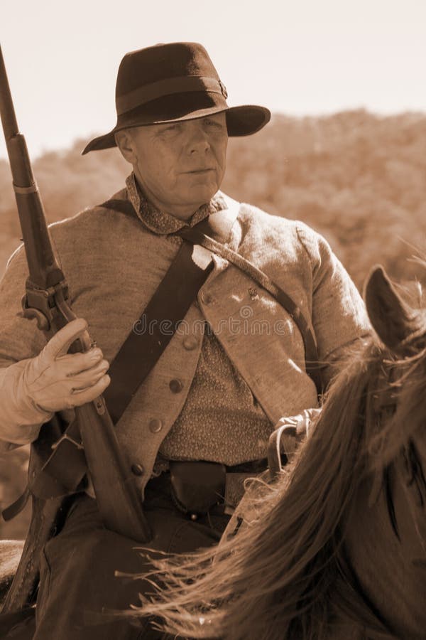 Buchanan, VA - April 26; A Civil War soldier on horseback with a musket rifle in Civil War period clothing at the Buchanan Civil War History Weekend on April 26, 2014, Buchanan, Virginia, USA. Buchanan, VA - April 26; A Civil War soldier on horseback with a musket rifle in Civil War period clothing at the Buchanan Civil War History Weekend on April 26, 2014, Buchanan, Virginia, USA.