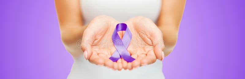 Ciérrese para arriba de las manos que sostienen la cinta púrpura de la conciencia imagenes de archivo