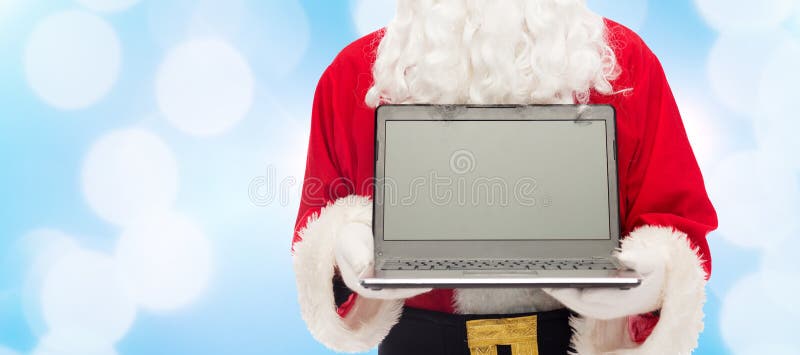 Ciérrese para arriba de Papá Noel con el ordenador portátil imagenes de archivo Ciérrese para arriba de Papá Noel con el ordenador portátil imagenes de archivo