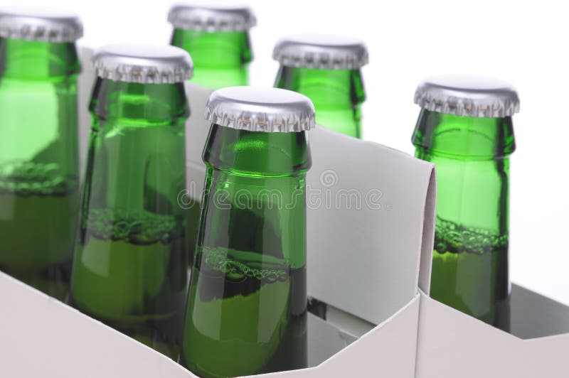 Close up of a Six Pack of Green Beer Bottles in Cardboard Carrier isolated on horizontal format. Close up of a Six Pack of Green Beer Bottles in Cardboard Carrier isolated on horizontal format