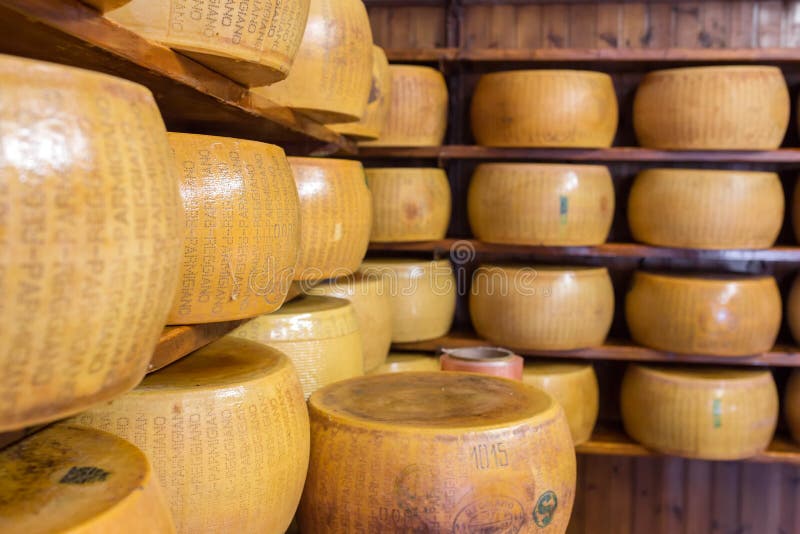 Ciérrese para arriba del queso parmesano duro italiano típico en los estantes imagen de archivo Ciérrese para arriba del queso parmesano duro italiano típico en los estantes imagen de archivo