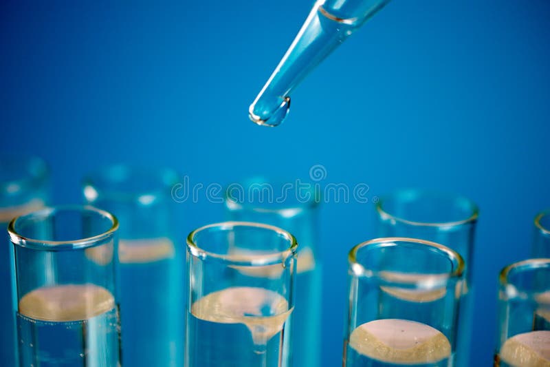 Glass test tubes with laboratory clear liquids, drops from a pipette. Science and laboratory research in the field of medicine. water test copy space, close up, selective focus , blurred background. Glass test tubes with laboratory clear liquids, drops from a pipette. Science and laboratory research in the field of medicine. water test copy space, close up, selective focus , blurred background