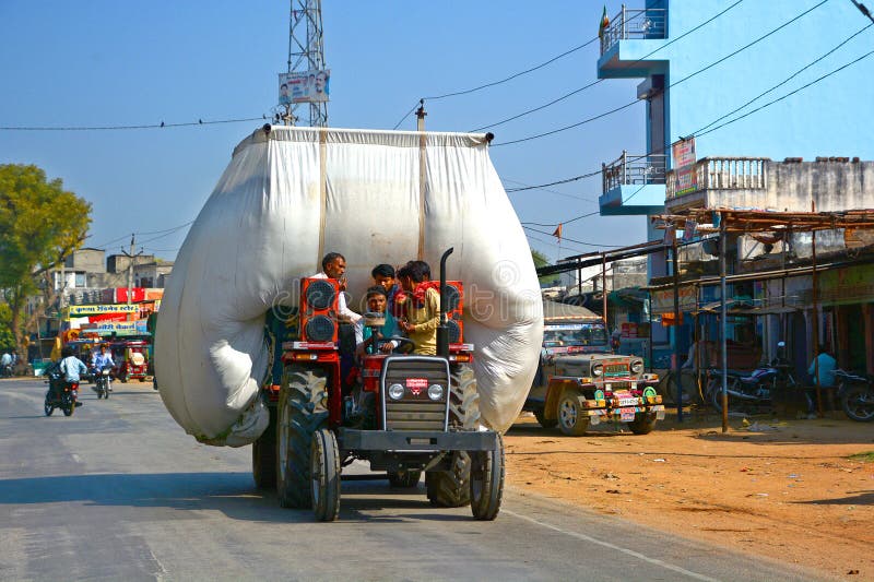 RURAL RAJASTHAN INDIA 02 23 2023: Tractor Is carrying hay and moving on road. RURAL RAJASTHAN INDIA 02 23 2023: Tractor Is carrying hay and moving on road.