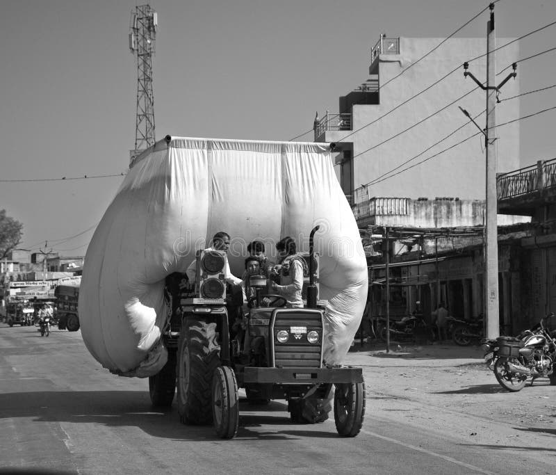 RURAL RAJASTHAN INDIA 02 23 2023: Tractor Is carrying hay and moving on road. RURAL RAJASTHAN INDIA 02 23 2023: Tractor Is carrying hay and moving on road.