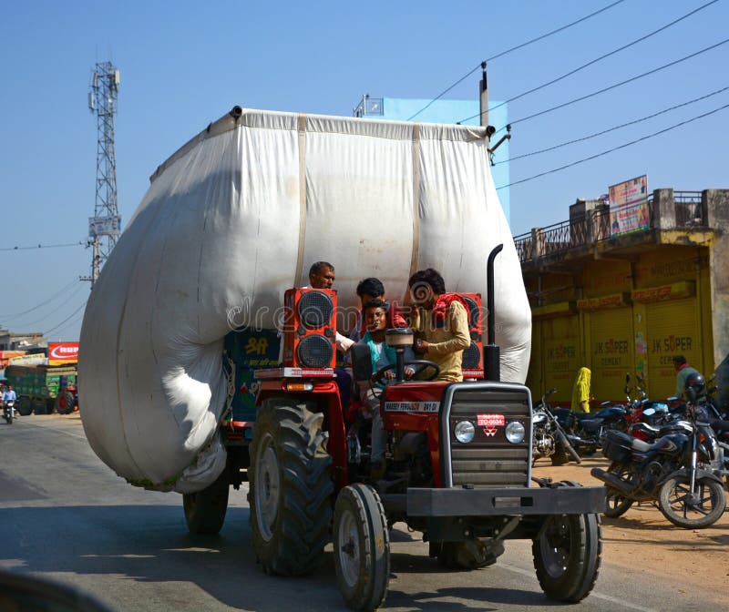 RURAL RAJASTHAN INDIA 02 23 2023: Tractor Is carrying hay and moving on road. RURAL RAJASTHAN INDIA 02 23 2023: Tractor Is carrying hay and moving on road.