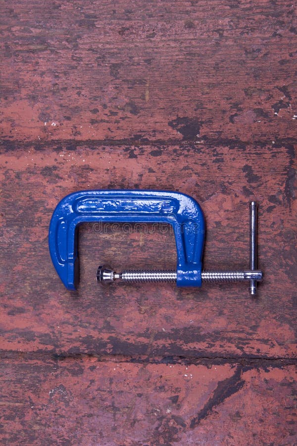 Old Fashioned Clamp Holding Curved Wood Being Used To Build a Wooden