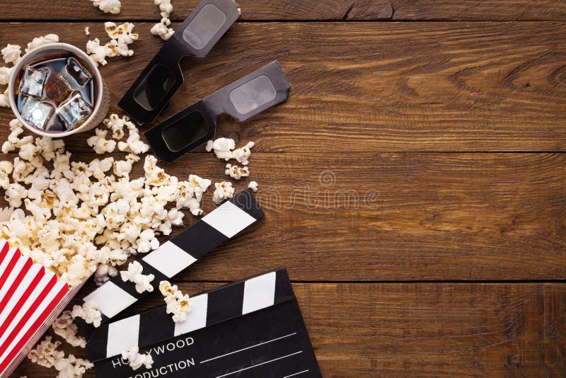 Clapperboard, film reel and popcorn on wooden background, top view royalty free stock image Clapperboard, film reel and popcorn on wooden background, top view royalty free stock image