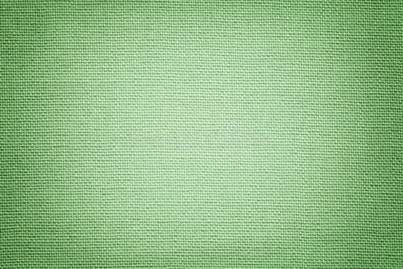Fundo verde claro de um material têxtil. Tecido com textura natural. Cenário imagem de stock royalty free
