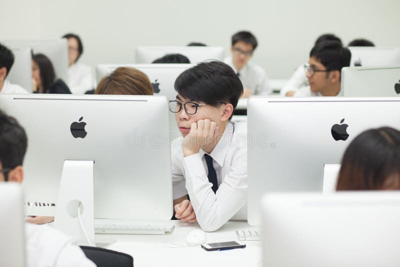 A class of students in front of their screens study computer science. stock image