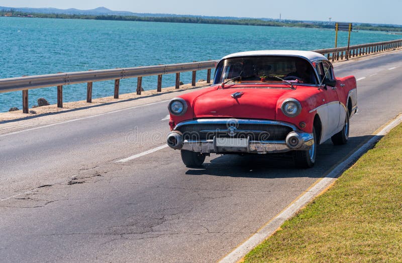 Classic American car on a seaside highway