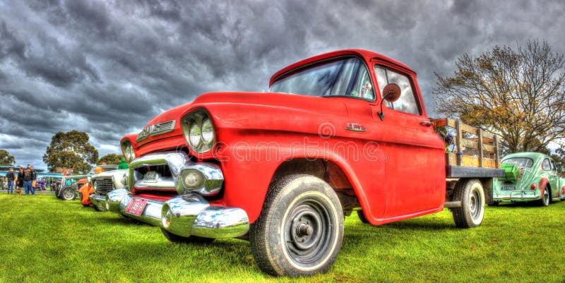 Classic American GMC pickup truck. Custom red American GMC pickup truck with wooden panels and flat bed on display at 2016 Greazefest a car and bike show held at stock images Classic American GMC pickup truck. Custom red American GMC pickup truck with wooden panels and flat bed on display at 2016 Greazefest a car and bike show held at stock images