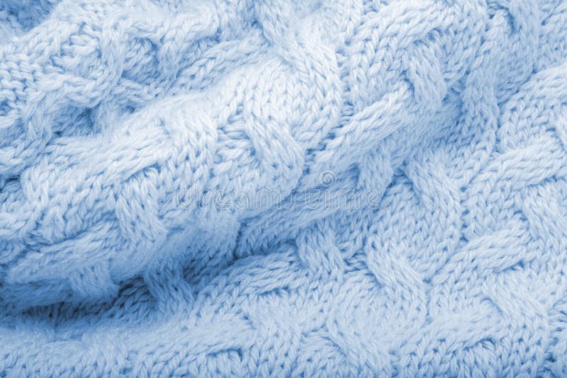 Classic blue knitted fabric wool texture for background. Close up of blue knitted material pattern for design. Blue warm sweater