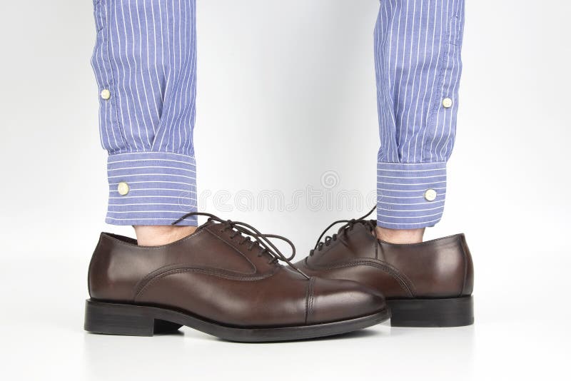 Classic Brown Shoes Worn on the Hands on a White Background Stock Image ...