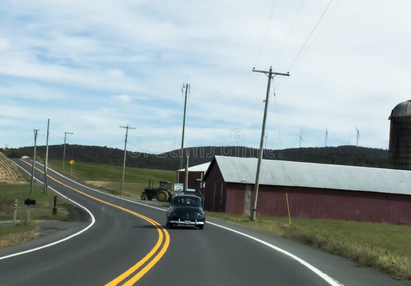 Classic car, farm, tractor, and country road Americana