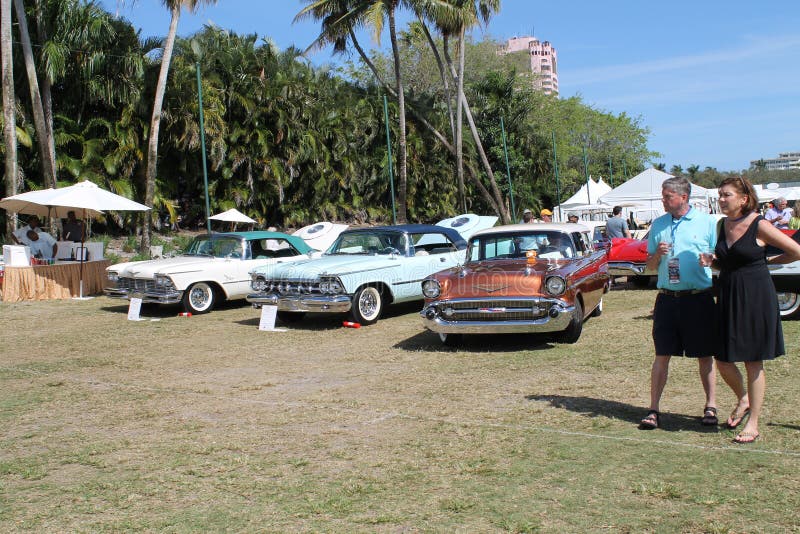 Classic large American luxury cars lined up in a row on a field at 2014 Boca Raton car event. three different Chrysler Imperial luxury cars. Classic large American luxury cars lined up in a row on a field at 2014 Boca Raton car event. three different Chrysler Imperial luxury cars