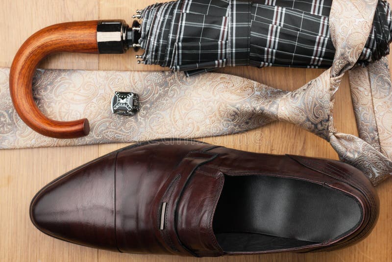 Classic mens shoes, tie, umbrella,cufflinks on the wooden floor royalty free stock image Classic mens shoes, tie, umbrella,cufflinks on the wooden floor royalty free stock image