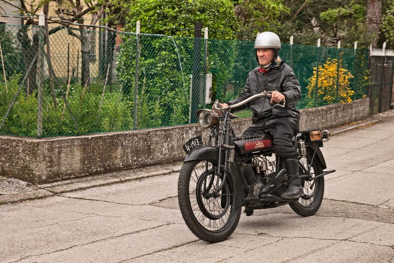 San Pietro in Trento, Ravenna, Italy - April 13, 2018: rider on a vintage English motorcycle Lea-Francis V-twin engine 1913 in classic motorbike rally `Circuito di San Pietro in Trento`. San Pietro in Trento, Ravenna, Italy - April 13, 2018: rider on a vintage English motorcycle Lea-Francis V-twin engine 1913 in classic motorbike rally `Circuito di San Pietro in Trento`