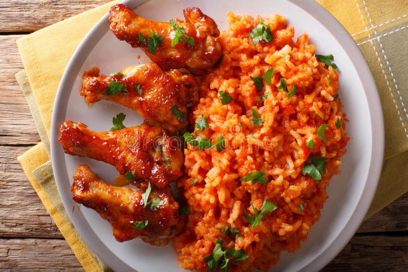 Classic Nigerian Jollofï¿½Rice with fried chicken wings close-up.