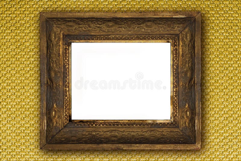 Classic old wooden picture frame carved by hand on gold wallpaper