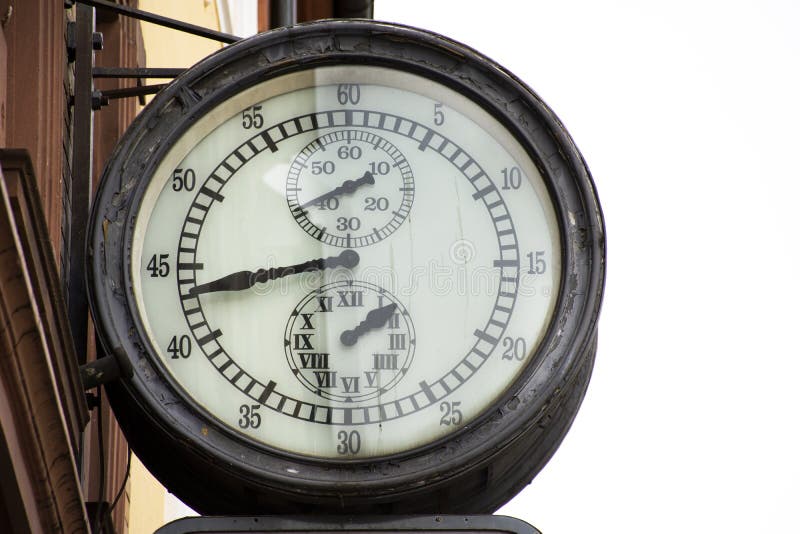 Classic retro vintage metal clock hanging on front of building in Heidelberg, Germany stock photos Classic retro vintage metal clock hanging on front of building in Heidelberg, Germany stock photos