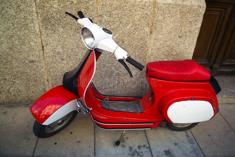 Classic scooter Vespa. Parked on a public street in France. Perpignan 14.07.2014. Vintage scooter wheel and body design details.Treviglio Lombardy Italy stock image Classic scooter Vespa. Parked on a public street in France. Perpignan 14.07.2014. Vintage scooter wheel and body design details.Treviglio Lombardy Italy stock image