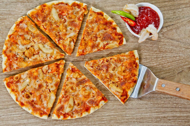 Classic Seafood Pizza with spicy chilli sauce. Classic Seafood Pizza with spicy chili sauce, Classic Seafood Pizza with white background at Bangladesh stock photo Classic Seafood Pizza with spicy chilli sauce. Classic Seafood Pizza with spicy chili sauce, Classic Seafood Pizza with white background at Bangladesh stock photo