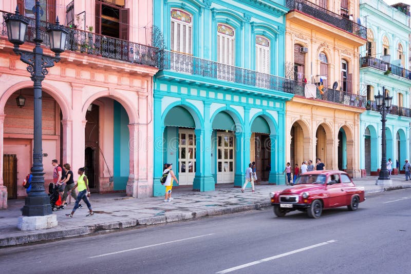 Classic vintage car and colorful colonial buildings in the main street of Old Havana stock photos Classic vintage car and colorful colonial buildings in the main street of Old Havana stock photos