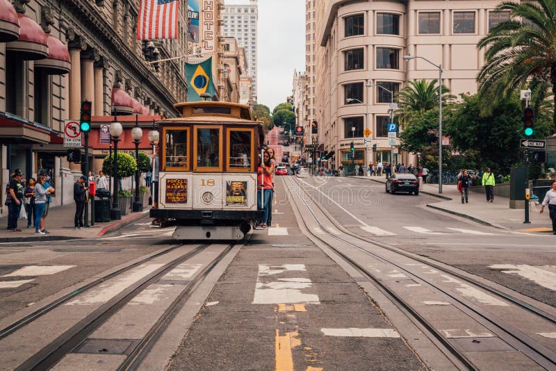 Classical cable car or a tram on the streets of San Francisco making classical u turn, USA.