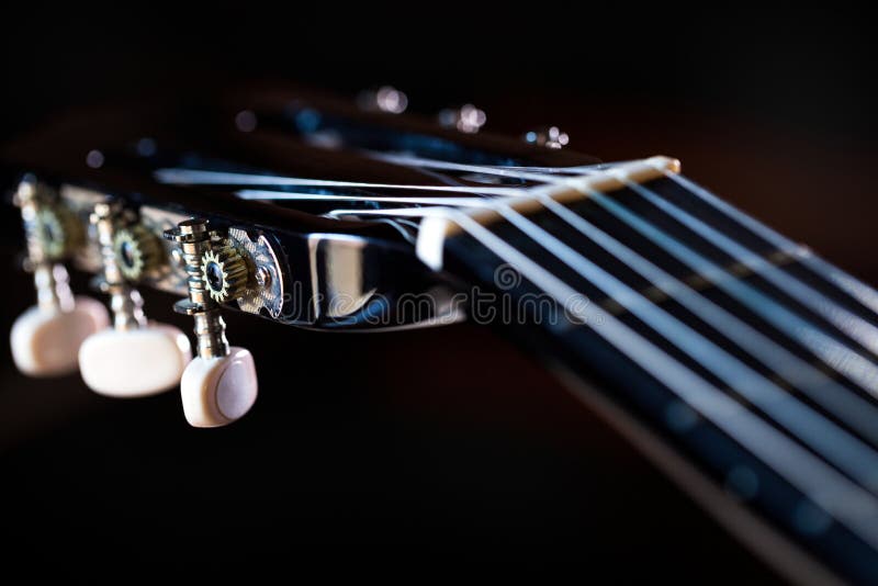 Headstock with Capo of Acoustic Guitar and Basic Chord. Stock Image