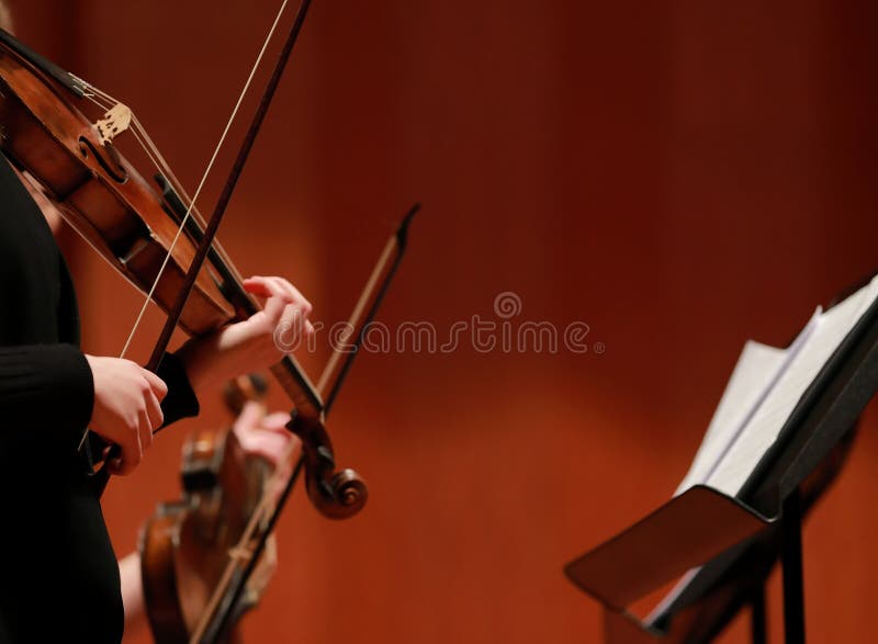 Classical music. Violinists in concert. Stringed, violinist.Closeup of musician playing the violin during a symphony