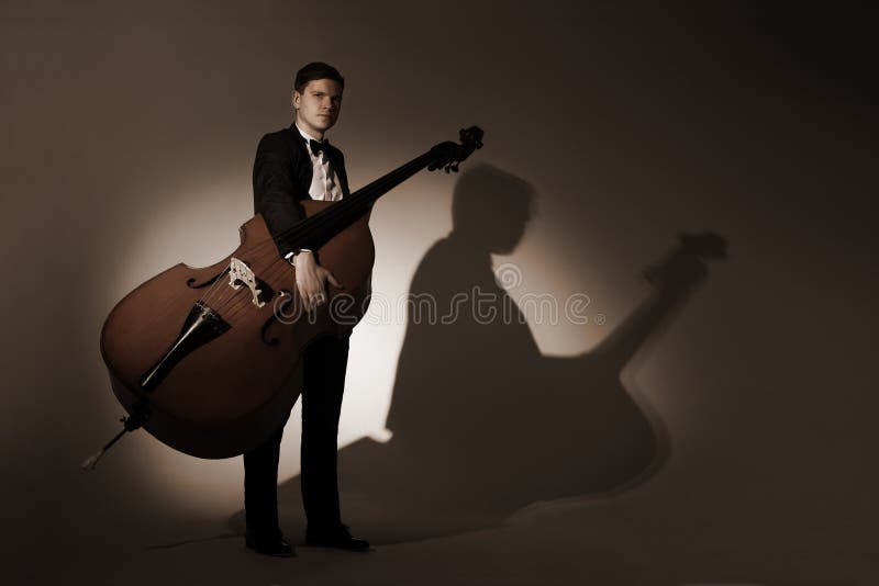 Classical musician studio portrait with double bass stock images