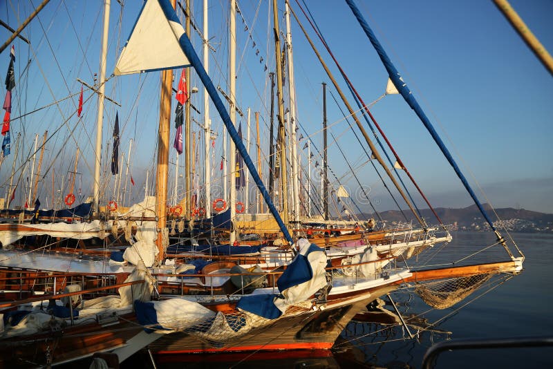 A classical wooden sailing boat moored by pier in Yalikavak Marine