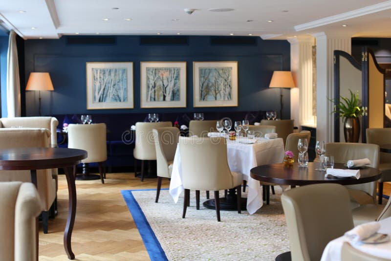 Classy elegant and modern restaurant at Amsterdam, The Netherlands in Europe. Seats, tables and lamps at luxury premium hotel. royalty free stock photo Classy elegant and modern restaurant at Amsterdam, The Netherlands in Europe. Seats, tables and lamps at luxury premium hotel. royalty free stock photo