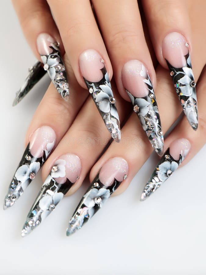 Female hands with floral pattern on nails. Female hands with floral pattern on nails.