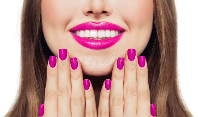 Nails and lips. Woman touching her cheeks her hands with manicure nails. Pink color lipstick and nail polish. Nails and lips. Woman touching her cheeks her hands with manicure nails. Pink color lipstick and nail polish.