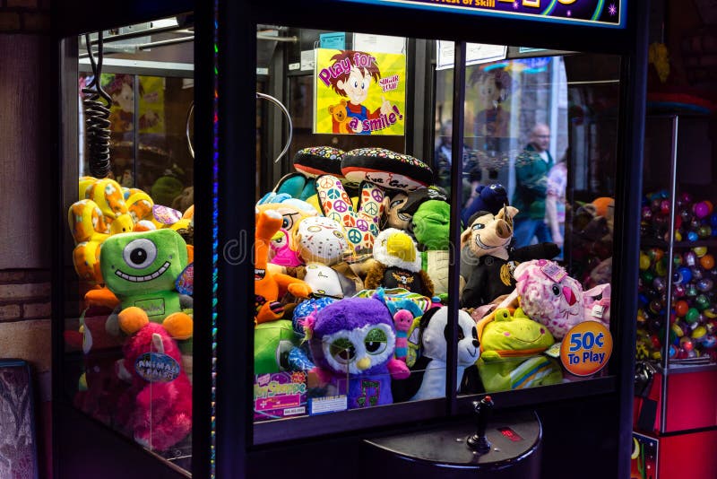 Claw game machine selling a chance to win a stuffed toy. Claw machine stock images, royalty-free photos and pictures