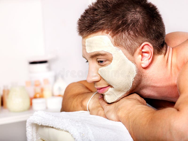 Clay facial mask in beauty spa.