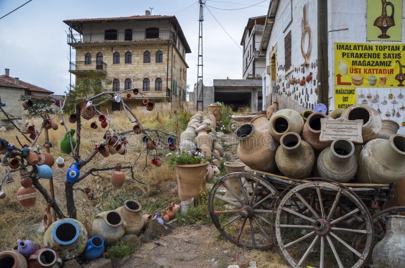 Rural landscape ,clay jugs on branches of a tree and old cart with ceramic jugs in Cappadocia village Cavusin, Turkey