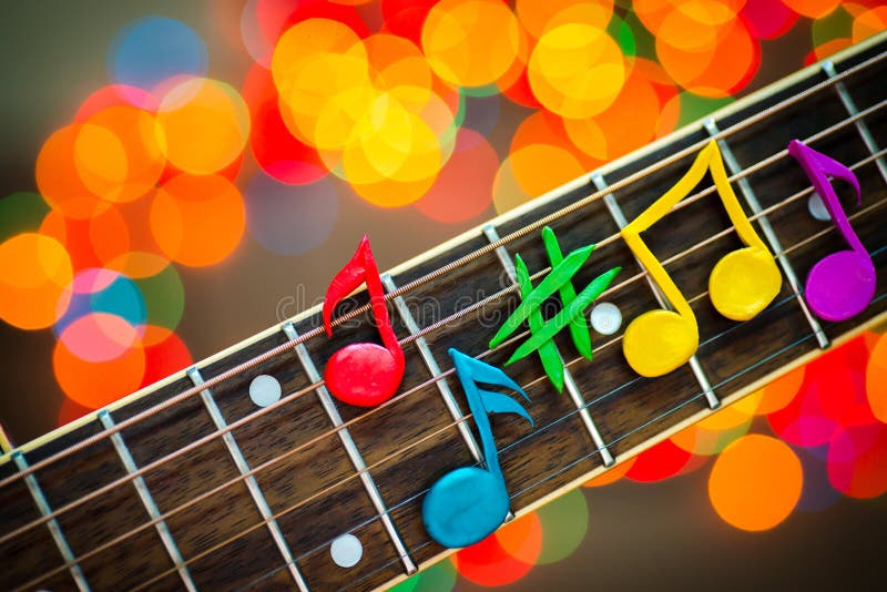 Learning guitar, colorful music notes closeup on bokeh background. Plasticine modeling. Colorful musical notes stock images, royalty-free photos and pictures