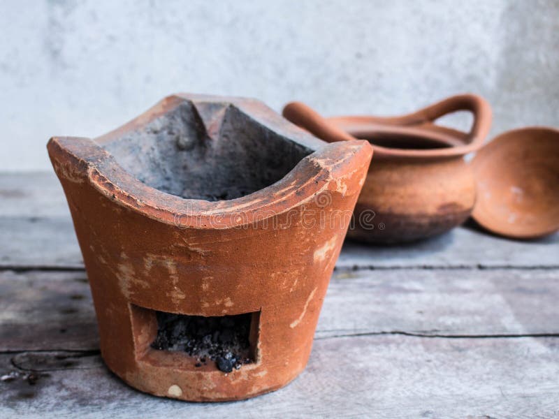 Charcoal and old clay pot stock photo. Image of house 59960376