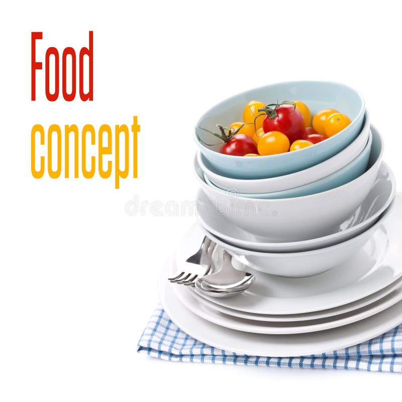 Clean bowls, plates and assorted cherry tomatoes, isolated