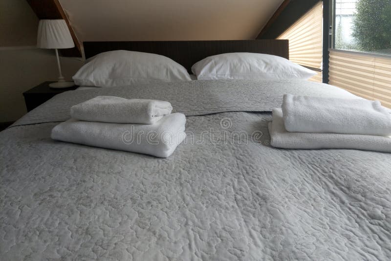 Clean Bright Bed with Towels. Hotel Room, Bedroom. Stock Photo Image