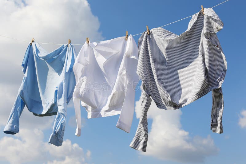 Clean Clothes Hanging on Washing Line Against Sky. Drying Laundry Stock ...