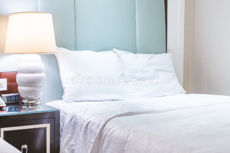 Clean and cozy modern hotel bedroom interior, warm tone room with a standing lamp, linen sofa with a cushion, design concept of.