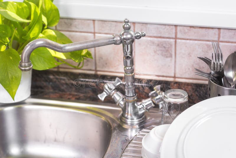 The Clean Dishes are Drying, on Rustic Kitchen Metal Sink. Stock Image