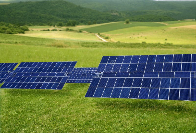Clean electric energy solar plates generators in a green meadow. Clean electric energy solar plates generators in a green meadow