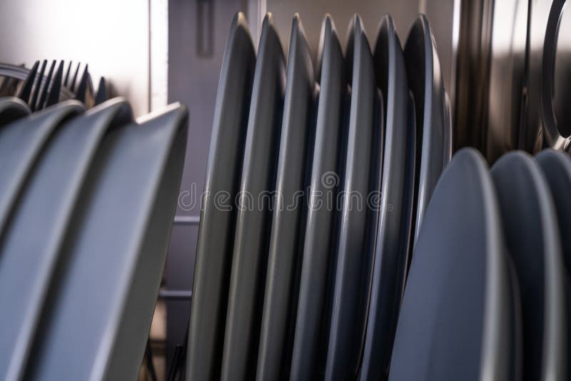 Clean gray plates in dishwasher stock image