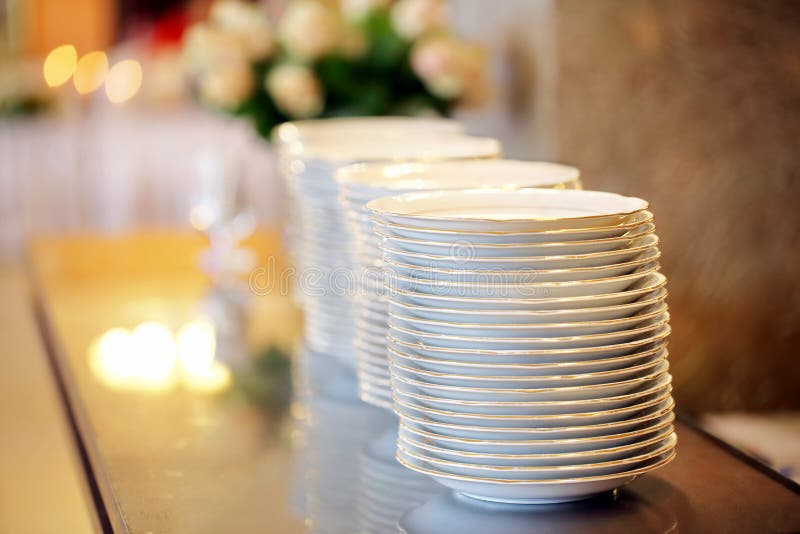 Clean Plates Ready To Serve at a Party or Wedding Celebration Stock