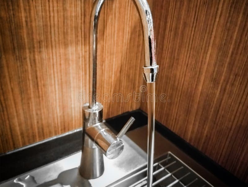 Clean Running Water on a Stainless Steel Kitchen Tap. Stock Image